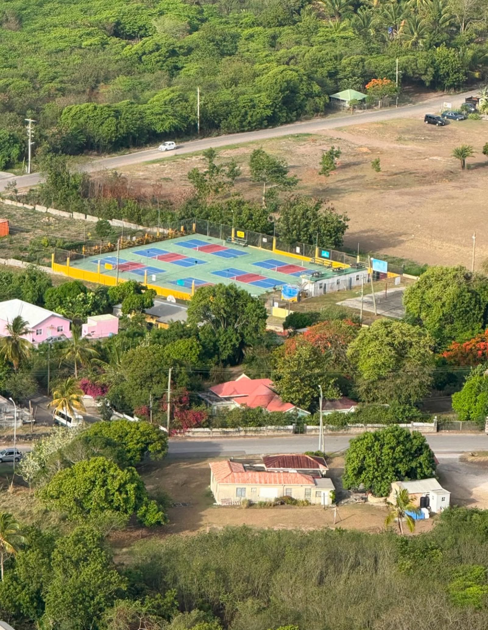 Aerial view of all six Pickleball268 Antigua courts nestled in the Falmouth hillside
