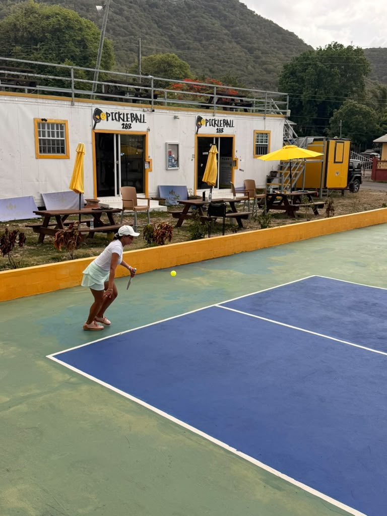 Player locked in, paddle ready, waiting to return serve